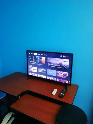 a computer monitor sitting on top of a wooden desk at Urban & Cozy in Guelph