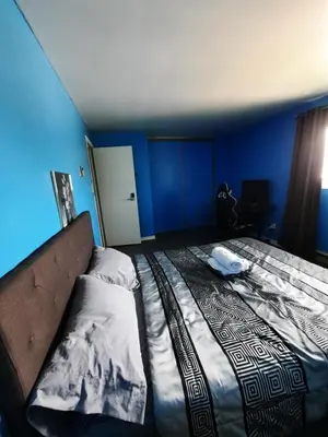 a bedroom with a bed in a blue room at Urban & Cozy in Guelph
