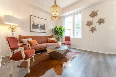 a living room with a couch and a table and chairs at Luxury Townhouse in Vaughan in Vaughan