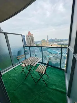 two chairs and a table on the balcony of a building at Modern One Bedroom Near Square One With Free Parking in Mississauga