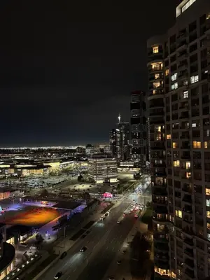 a night view of a city with buildings at Modern One Bedroom Near Square One With Free Parking in Mississauga