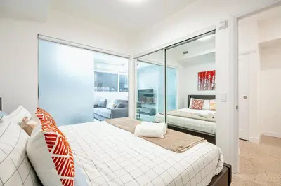 a bedroom with a bed and a mirror at Chic 2BR Basement Suite 2BR Toronto Getaway near Downtown - The Roland in Toronto