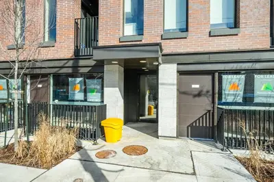 a yellow trash can in front of a building at Inviting 2BR Basement Suite in Downtown Toronto - The Roland in Toronto