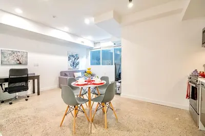a kitchen and dining room with a table and chairs at Inviting 2BR Basement Suite in Downtown Toronto - The Roland in Toronto