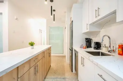 a kitchen with white countertops and a sink at Peaceful 2BR Basement Suite Near Downtown Toronto - The Roland in Toronto