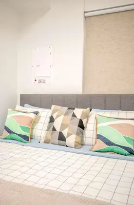 a bed with colorful pillows on top of it at Peaceful 2BR Basement Suite Near Downtown Toronto - The Roland in Toronto