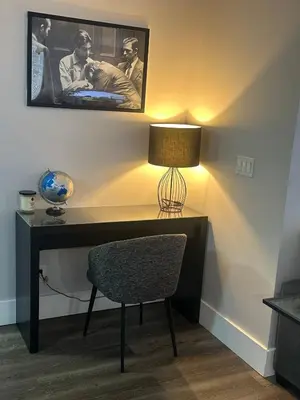a desk with a lamp and a chair in a room at Stylish 2BR Suite by Square One in Mississauga