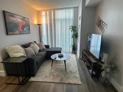a living room with a couch and a table at Stylish 2BR Suite by Square One in Mississauga