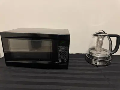 a microwave sitting on a counter next to a blender at Modern Luxury Basement Suite in Oakville