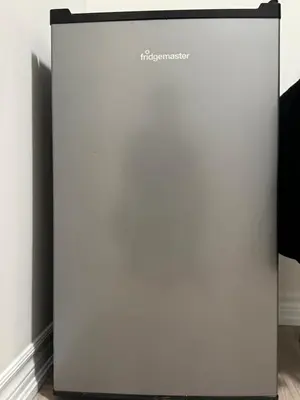 a white refrigerator in a room at Modern Luxury Basement Suite in Oakville