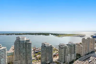 a city with tall buildings and a body of water at Luxury Lakeview Downtown Condo, CN Tower, Rogers Center, Scotia Arena, Lake View with Free Parking in Toronto