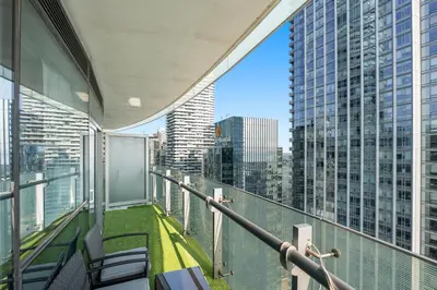 a balcony of a building with a view of a city at Luxury Lakeview Downtown Condo, CN Tower, Rogers Center, Scotia Arena, Lake View with Free Parking in Toronto