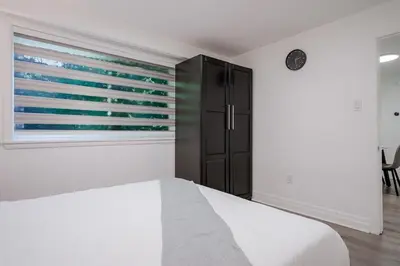 a bedroom with a bed and a window at 2 Bed 2 Bath Bunglow in Mississauga Yyz PortCredit in Mississauga