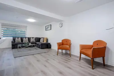 a living room with two chairs and a couch at 2 Bed 2 Bath Bunglow in Mississauga Yyz PortCredit in Mississauga