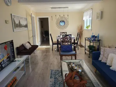 a living room with a blue couch and a table at 2 Bedroom house in East-York in Toronto