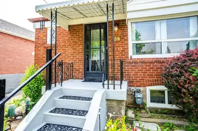 a brick house with a front door and stairs at 2 Bedroom house in East-York in Toronto