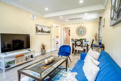 a living room with a blue couch and a table at 2 Bedroom house in East-York in Toronto