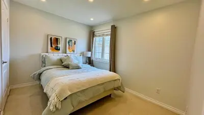 a bedroom with a bed and a window at Spacious 4BD Oasis with Sauna in Mississauga