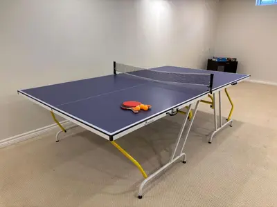 a ping pong table with a toy on it at Spacious 4BD Oasis with Sauna in Mississauga
