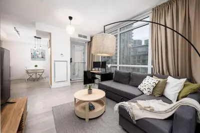 a living room with a couch and a table at Top Graded Metropolitan Suite with Free Parking in Toronto