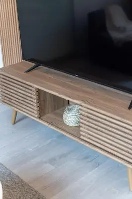 a flat screen tv on top of a wooden entertainment center at Top Graded Metropolitan Suite with Free Parking in Toronto