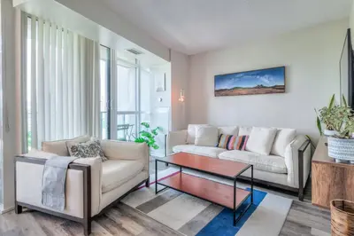 a living room with a couch and a coffee table at Chic 1BR plus Den Condo with Fast WiFi and Free Parking in Toronto