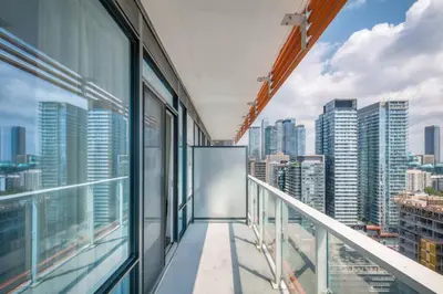 a balcony in a skyscraper with views of the city at Downtown 1BR City Stay with Balcony and Fast Wi-Fi in Toronto