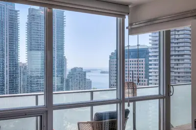 a room with a large window with a view of the city at 1BR plus Den Condo with Balcony in Heart of Toronto in Toronto