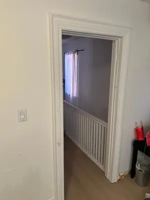 a hallway with a door leading to a room at Goldwin's Place in Toronto