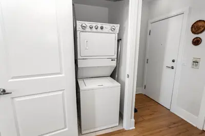 a kitchen with a white stove and a refrigerator at Lavish 2BR 2Bath Condo Steps to Square One Mall in Mississauga