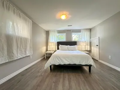 a bedroom with a large bed and a window at Mountain View House - Sleeps 14 in St. Catharines