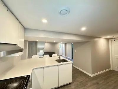 a kitchen with white cabinets and a counter top at Mountain View House - Sleeps 14 in St. Catharines