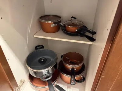 a kitchen with pots and pans sitting on shelves at Large Downtown 2Br condo with Parking steps to Eaton Centre, UofT and SickKids in Toronto
