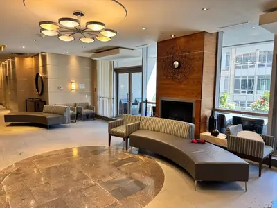 a lobby with couches and a fireplace in a building at Large Downtown 2Br condo with Parking steps to Eaton Centre, UofT and SickKids in Toronto