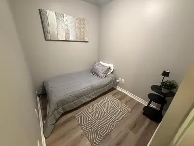 a small room with a bed and a rug at Large Downtown 2Br condo with Parking steps to Eaton Centre, UofT and SickKids in Toronto