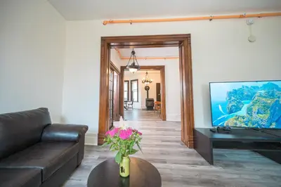 a living room with a couch and a tv at Comic House with Climbing Wall & Themes in Chesley