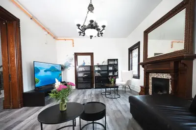 a living room with a couch and a fireplace at Comic House with Climbing Wall & Themes in Chesley