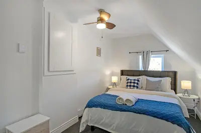 a bedroom with a bed with two towels on it at The Dove Loft Near DT & Hospital in Peterborough