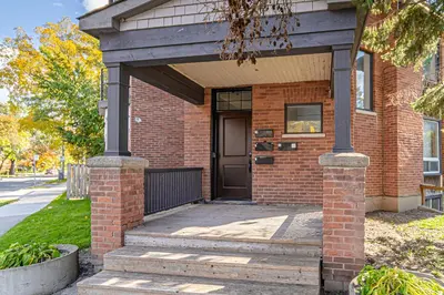 a brick house with a black door on a street at The Dove Loft Near DT & Hospital in Peterborough