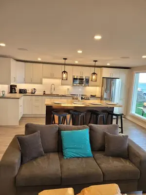 a living room with a couch and a kitchen at 5 o clock somewhere in Hamilton