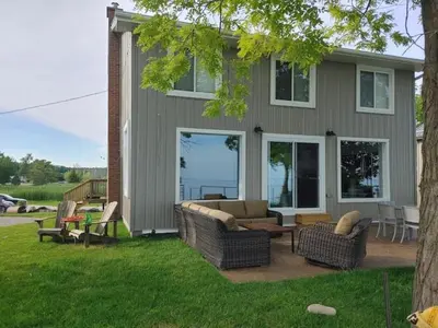 a house with a patio with chairs and a table at 5 o clock somewhere in Hamilton