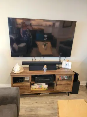 a wooden entertainment center with a tv on top of it at 5 o clock somewhere in Hamilton