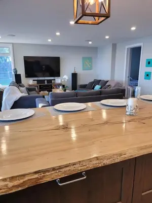 a kitchen with a wooden counter top in a living room at 5 o clock somewhere in Hamilton