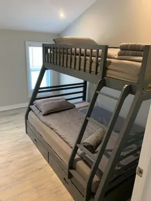 a bedroom with two bunk beds in a room at 5 o clock somewhere in Hamilton