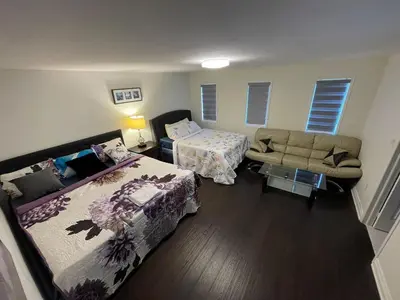 a room with two beds and a couch in it at Largest ensuite bedroom in a guest house in Whitby
