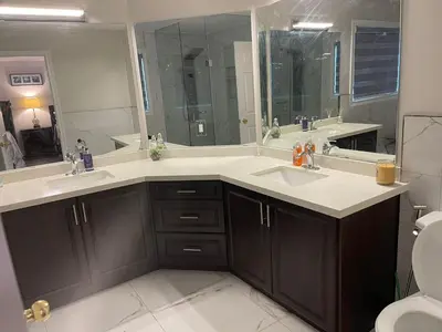 a bathroom with two sinks and a large mirror at Largest ensuite bedroom in a guest house in Whitby