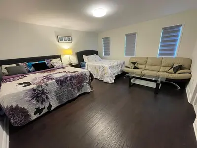 a living room with two beds and a couch at Largest ensuite bedroom in a guest house in Whitby