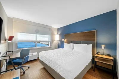 a bedroom with a bed and a desk and a chair at Tru By Hilton Oshawa in Oshawa