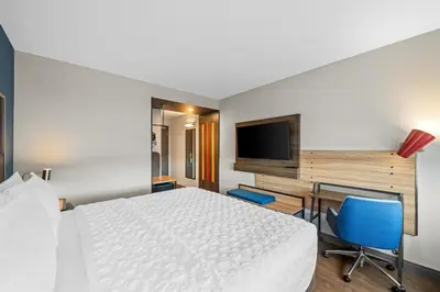 a hotel room with a bed and a desk and a television at Tru By Hilton Oshawa in Oshawa