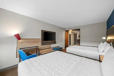 a hotel room with two beds and a tv at Tru By Hilton Oshawa in Oshawa